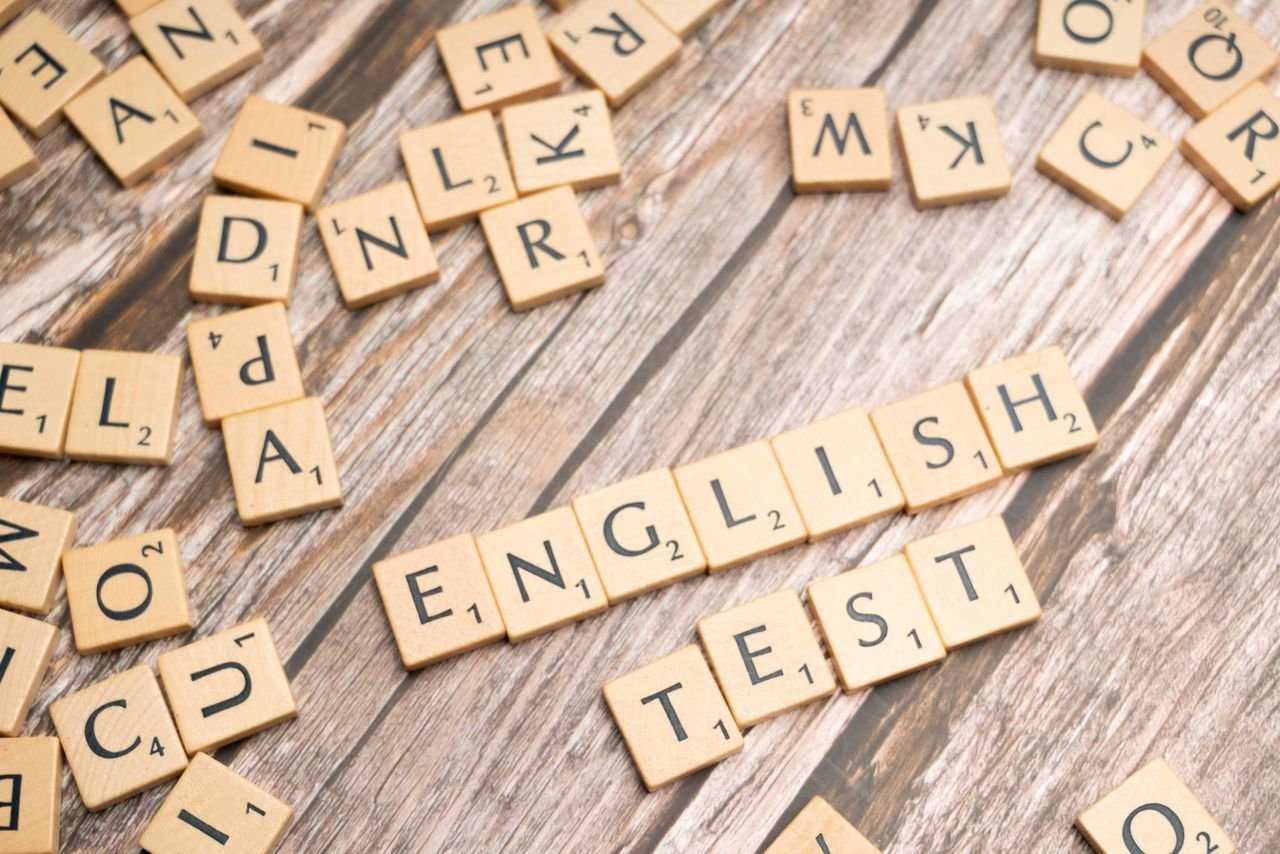 Crafting Captivating Headlines: Your awesome post title goes here Wooden Scrabble tiles spelling out English Test on a wooden background, ideal for language exam themes.
